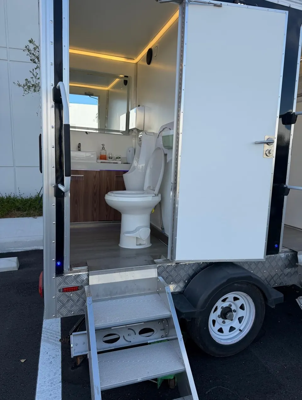 Restroom trailer entrance with steps and open door