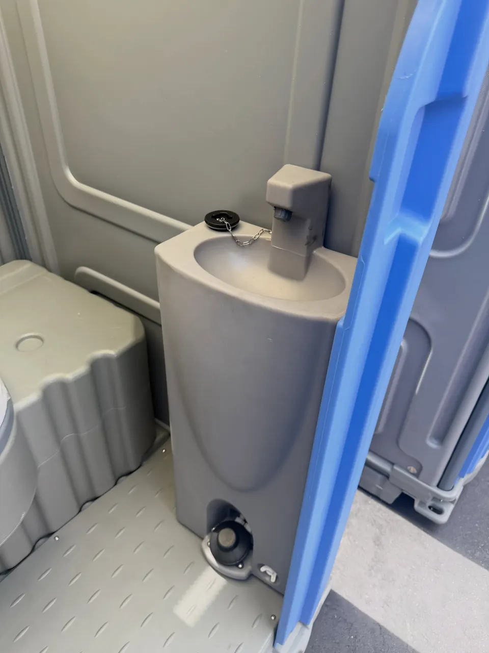 Compact sink inside a portable restroom