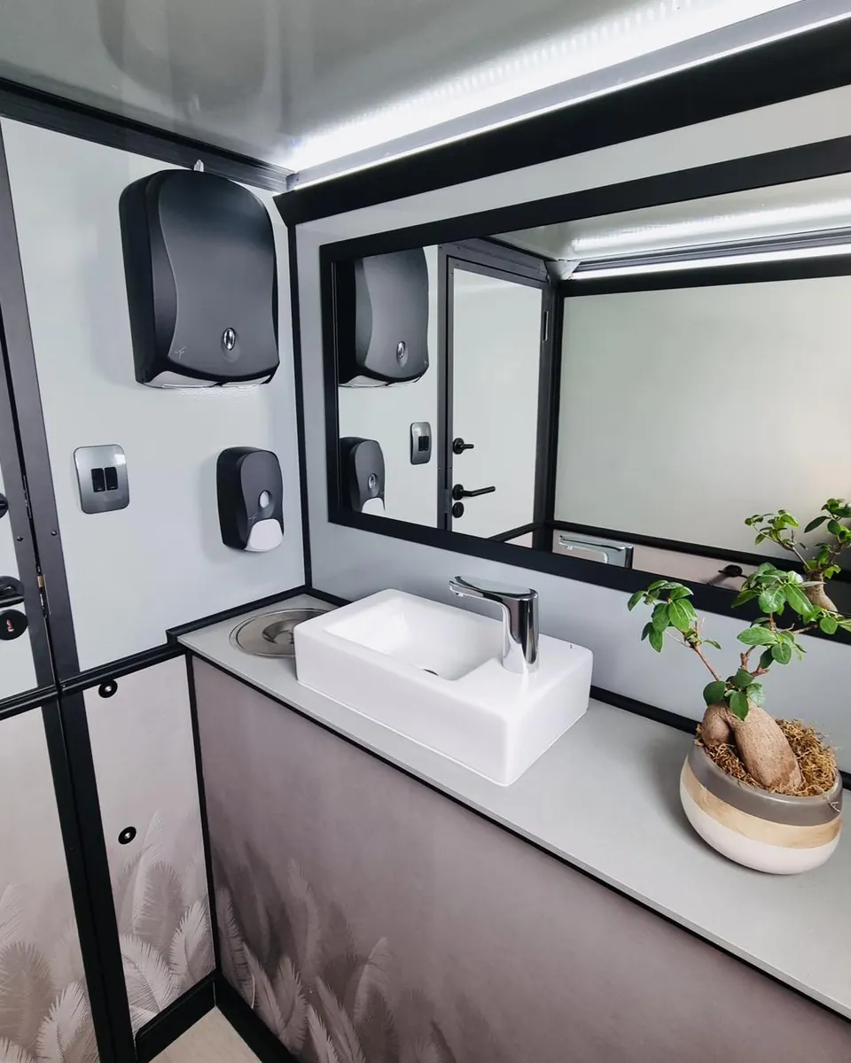 Restroom trailer vanity with sink and mirror